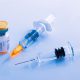 closeup-two-syringes-beside-vial-vaccine-flu-covid-19-measles-other-diseases-01