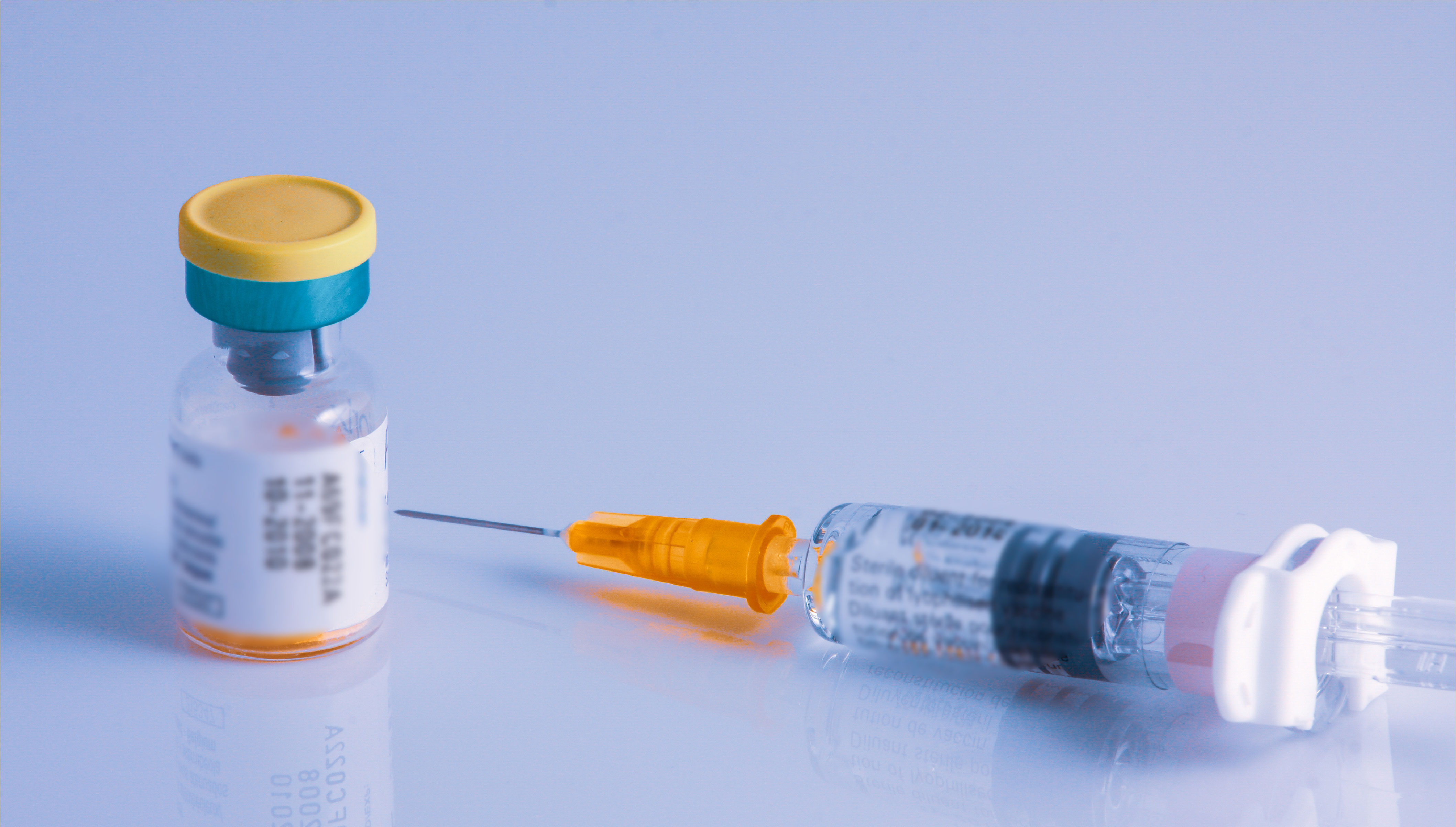 closeup-two-syringes-beside-vial-vaccine-flu-covid-19-measles-other-diseases